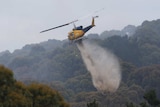 Helicopter waterbombs a fire at Bruny Island, Tasmania, Christmas Day, 2018.