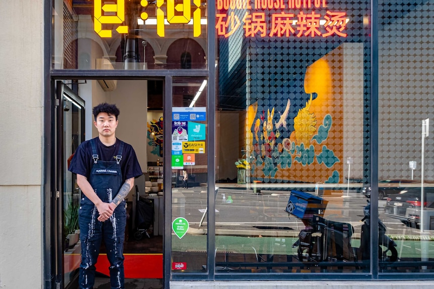 Shiwei Ding standing in the doorway of his restaurant Boogie House Hotpot