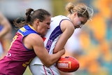 Brisbane Lions' Breanna Koenen drags down Fremantle Dockers' Nikki Gore during an AFLW match.