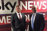 Blair Cottrell and Adam Giles standing in front of a massive Sky News banner