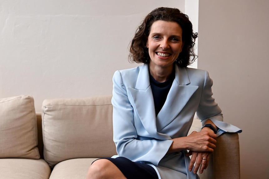 a woman sitting down and smiling