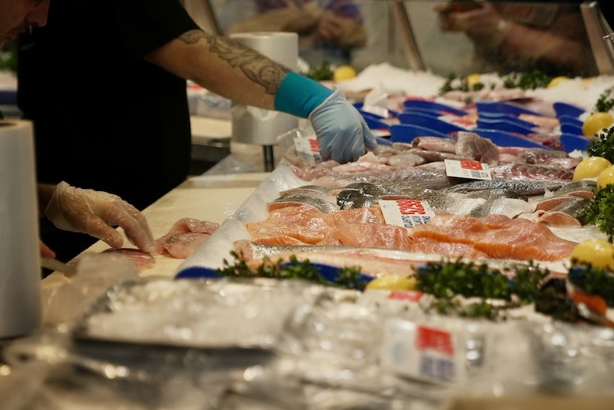 Fish market workers preparing orders for customers.