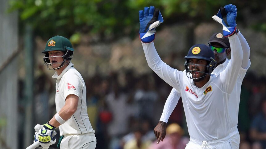 Sri Lanka's wicketkeeper Dinesh Chandimal celebrating and cheering the dismissal of Australian captain Steven Smith.