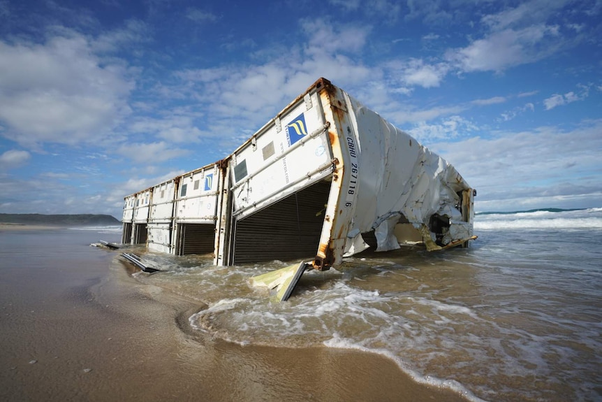 Shipping container sits in water