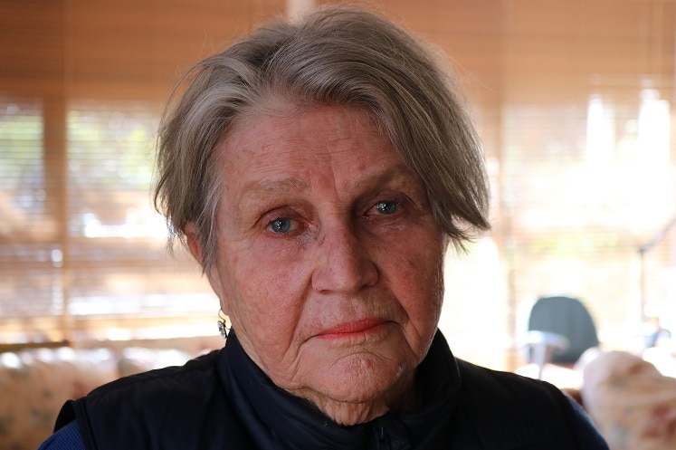 Julia Ryan stands in her living room.