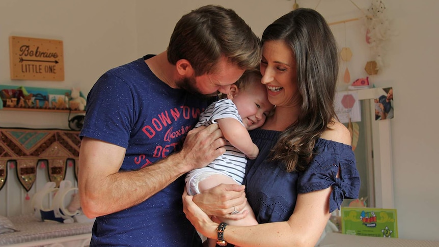 A family portrait of Bethan, Johnny and Aviana McElwee in their daughter's bedroom.