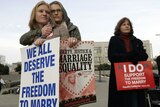 Elizabeth Chase (L) and Kate Baldridge embrace outside the federal courthouse in San Francisco