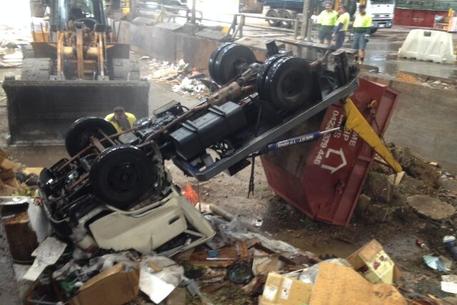 The truck tipped over at the Chandler Transfer Station on Saturday morning.