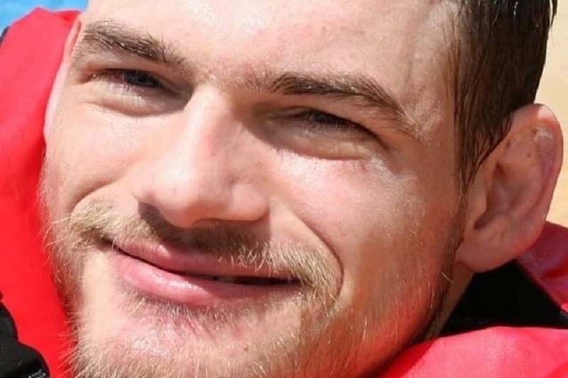 Close shot of Lachlan Moore smiling wearing a life vest in a pool.