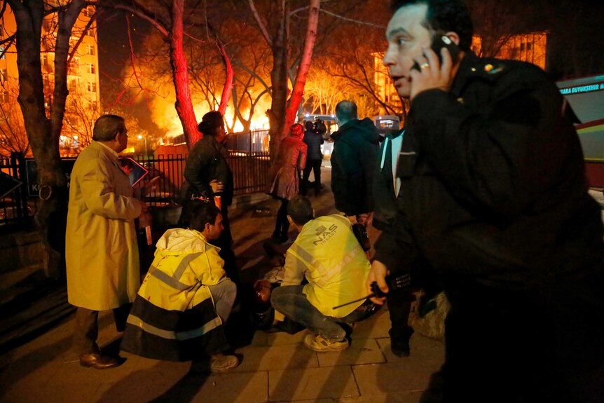 Emergency workers help an injured person at the scene of an explosion in Ankara.