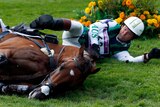 Clayton Fredericks lays near his horse, Bendigo, after a fall in the Eventing Cross Country.