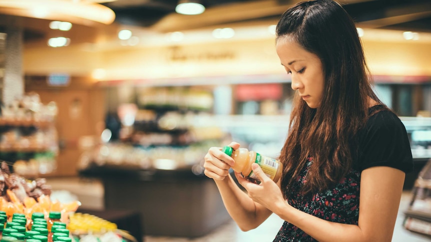 Woman looking at food label