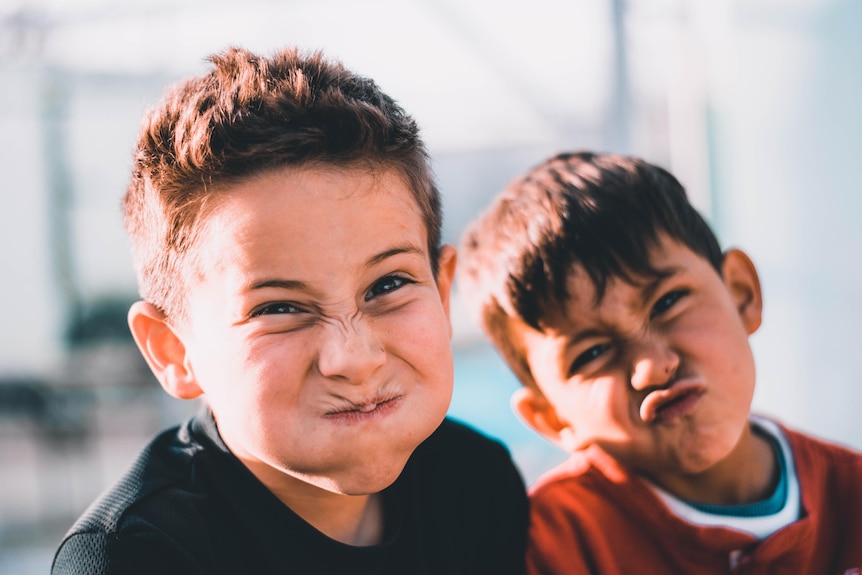 Two boys pulling silly faces