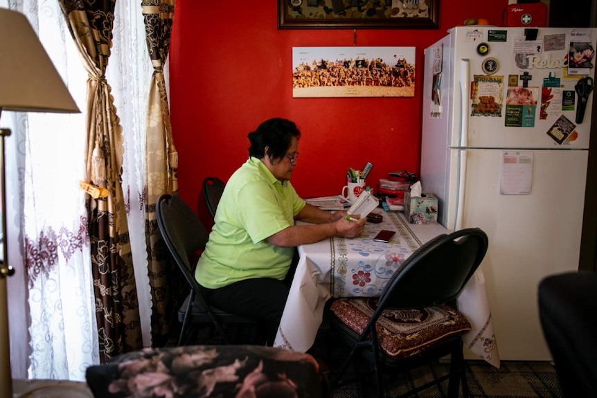 A woman sat in her home