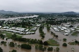 Houses surrounded by floodwaters as seen by a drone.
