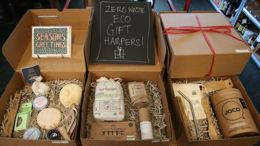 Three Christmas hampers that include eco-friendly products and are encased in cardboard packaging rather than plastic