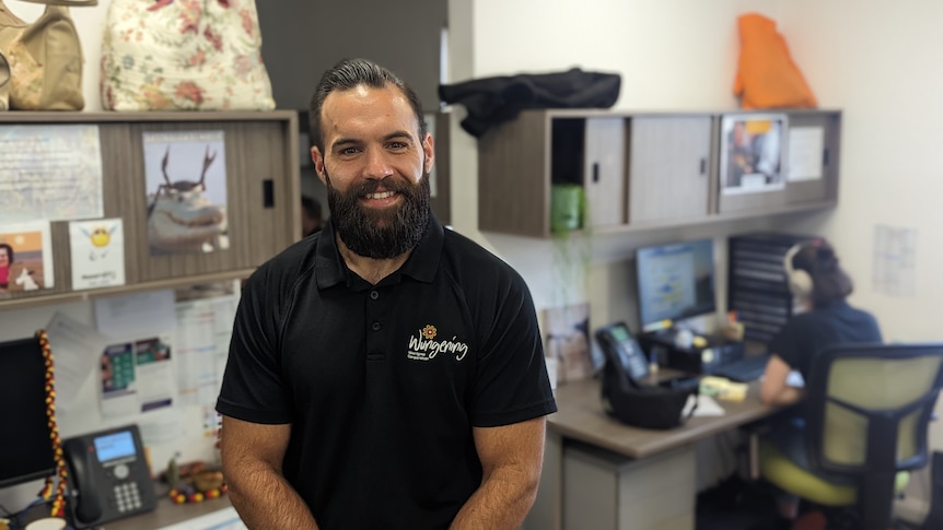 A portrait from above of Keiran Dent from Wungening smiling and standing in an office 