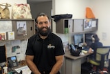 A portrait from above of Keiran Dent from Wungening smiling and standing in an office 