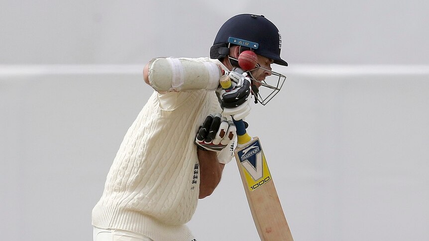 James Anderson is hit on the helmet by a ball.