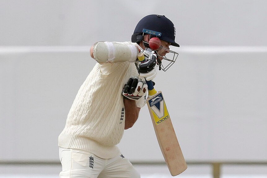 James Anderson is hit on the helmet by a ball.