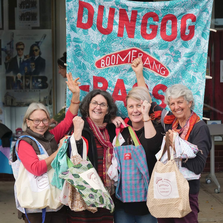 Four women in front of a giant cloth bag with Boomerang Bags logo.