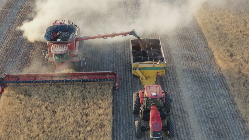 A drone shot capturing a harvest machine at work in a paddock.