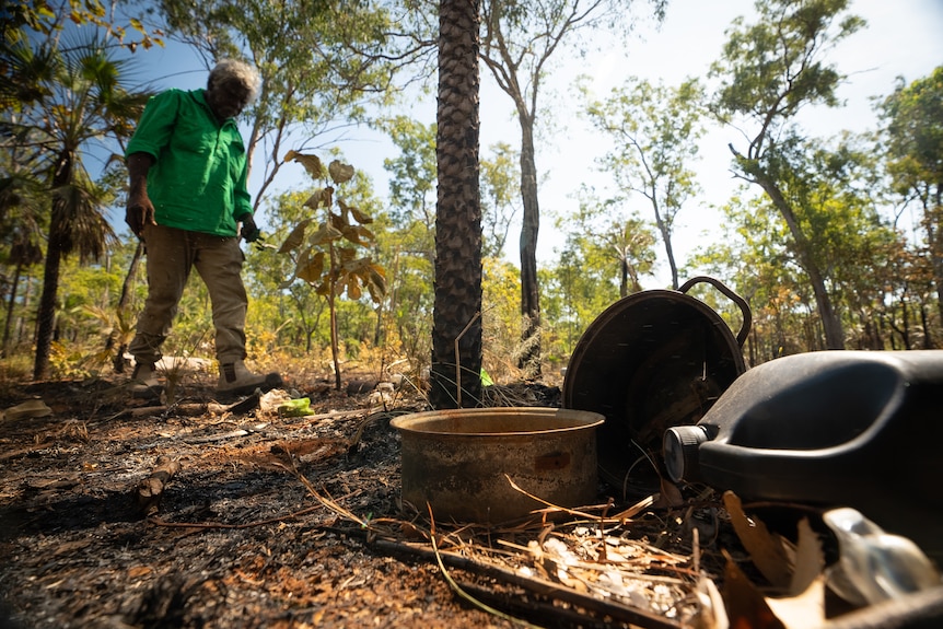 Leon Melpi walking through a campsite.