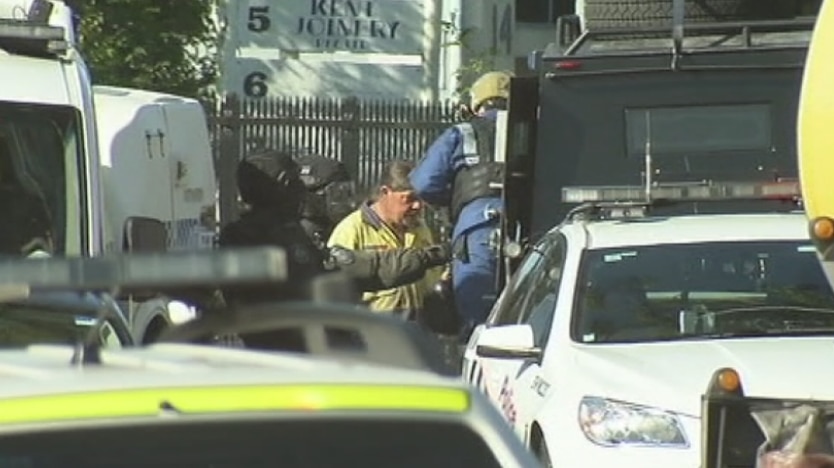 One of three people seen being placed into an armoured police vehicle