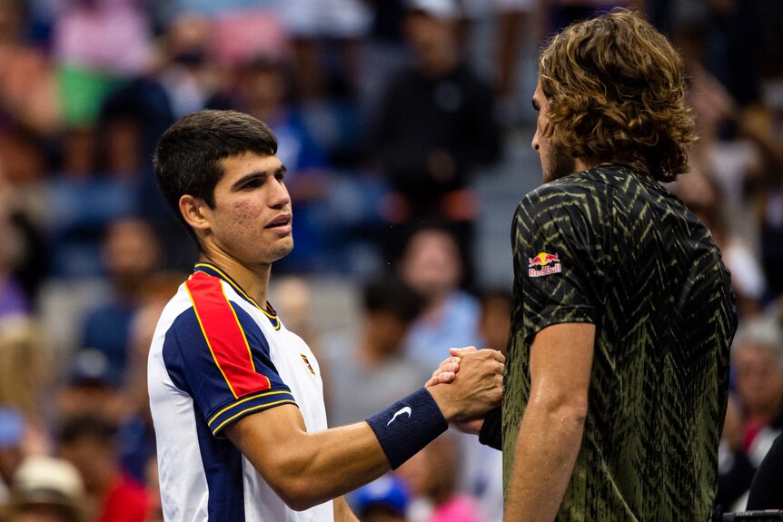 Two tennis players shaking hands after a match 