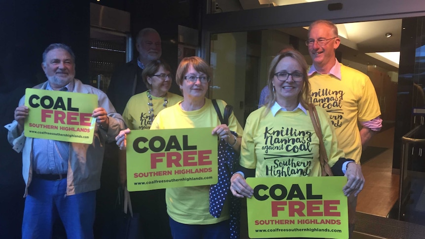 Six people gather outside court after hearing they won a challenge against Hume Coal.
