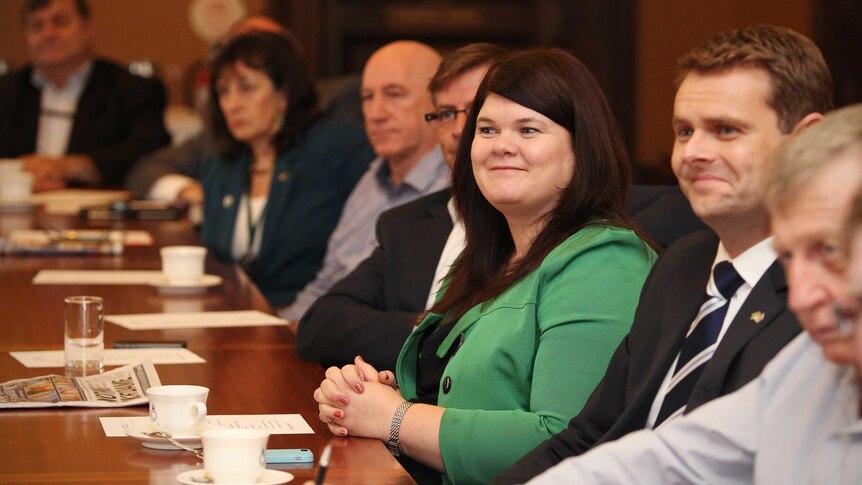 Zoe Bettison, wearing green, and Stephen Mullighan, seated on her left side, attend a Caucus meeting in Adelaide.