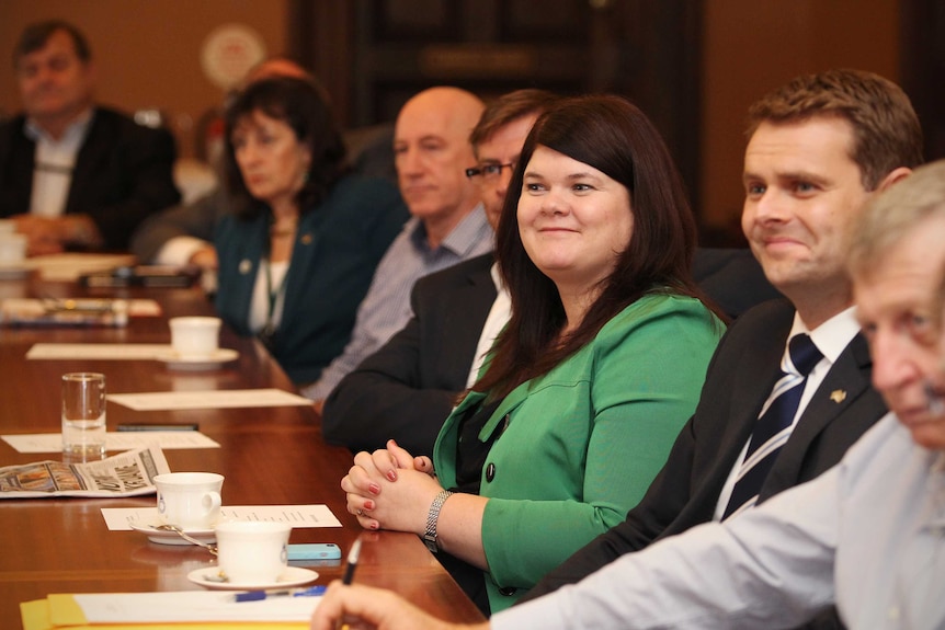 Zoe Bettison, wearing green, and Stephen Mullighan, seated on her left, attend a Caucus meeting in Adelaide