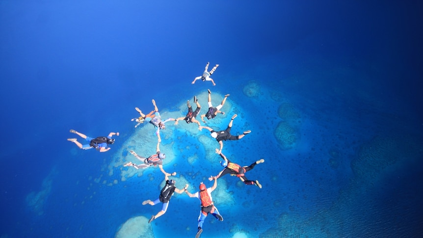 Andre Hansen jumping onto Beaver Cay, Great Barrier Reef
