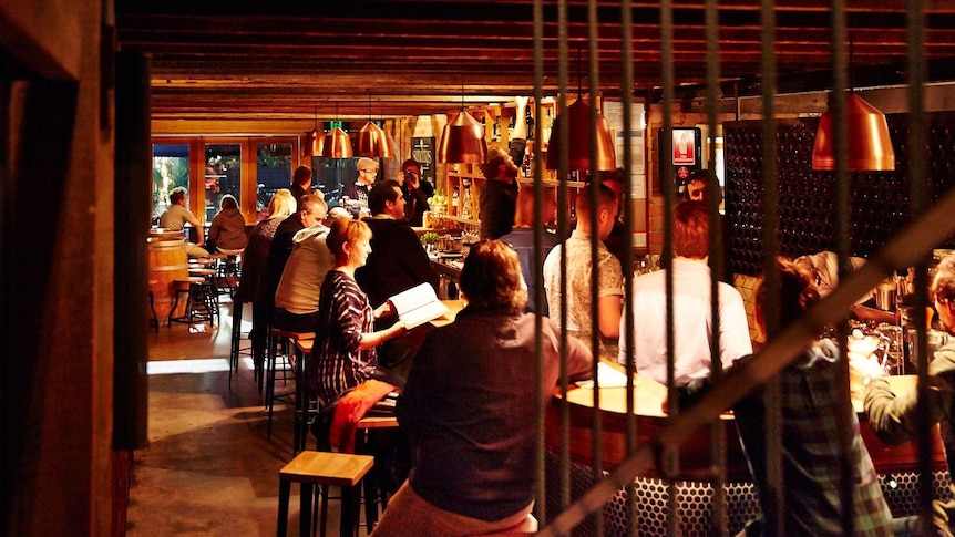 Patrons pack a small bar in Adelaide.