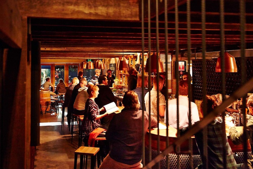 Patrons pack a small bar in Adelaide.