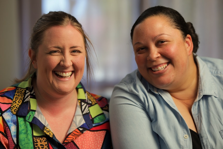 Two women smiling.