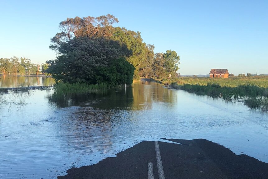 Floodwaters over a tar road 