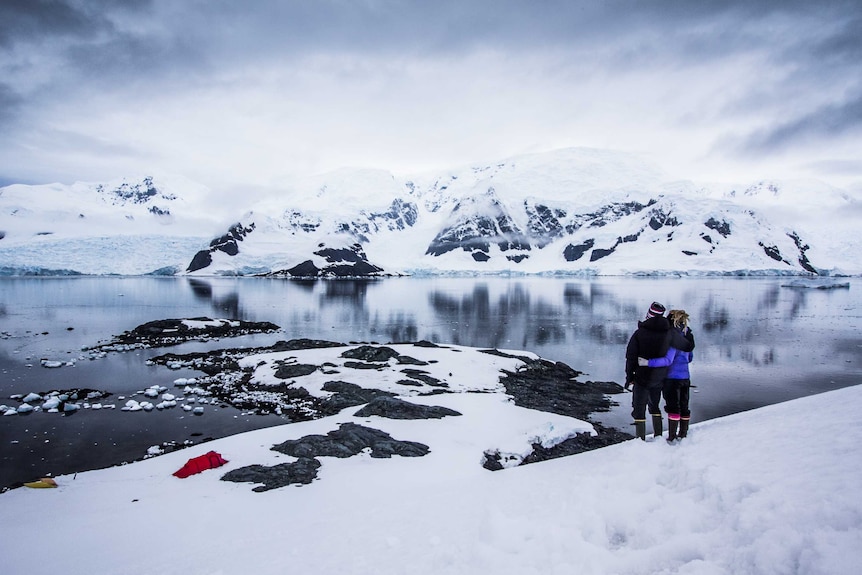Sophie Ballagh and Ewan Blyth look out at the view from a icy hill above their campsite on the Antarctic Peninsula.