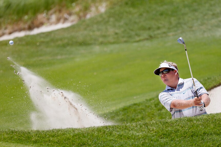 Carl Pettersson hits out of a bunker on the 17th hole on his way to the first-round lead.
