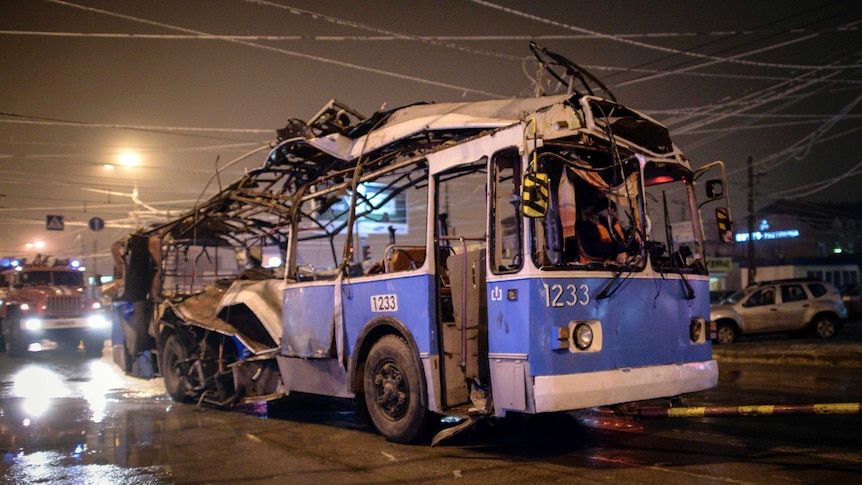 A trolleybus destroyed by an explosion in Volgograd, Russia, is towed away.