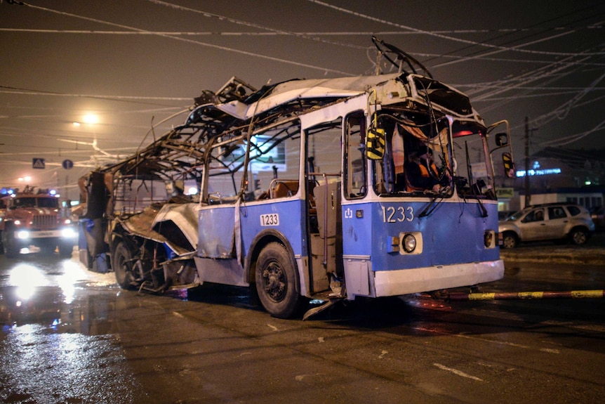 A trolleybus destroyed by an explosion in Volgograd, Russia, is towed away.