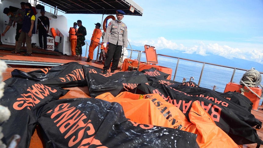 Body bags line an Indonesian SAR vessel after ferry sinks