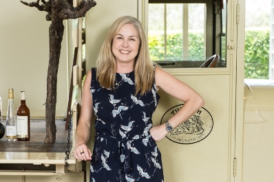 A woman stands in a winery