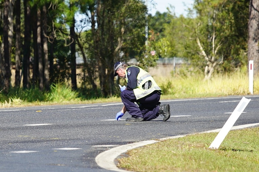 Police officer at scene of where a 45-year-old man's body was found on the road.