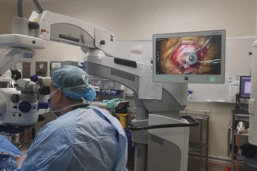 A surgeon in theatre with an eye on the screen. 