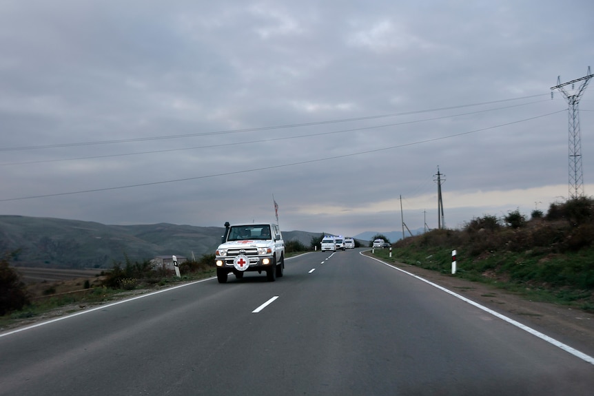 The motorcade with the first group of about 30 people drive from Nagorno-Karabakh to Armenia.