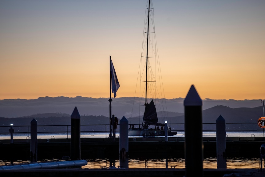 A yacht in a harbour in morning light.