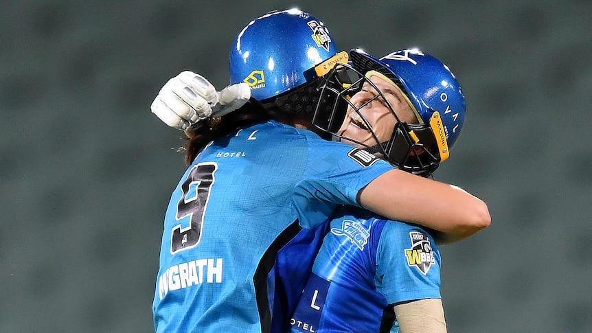 Tahlia McGrath and Katie Mack hug on the pitch