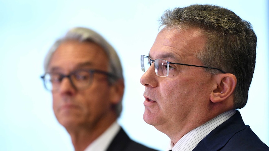 Chris Nikou speaks at an FFA media conference as David Gallop looks on.