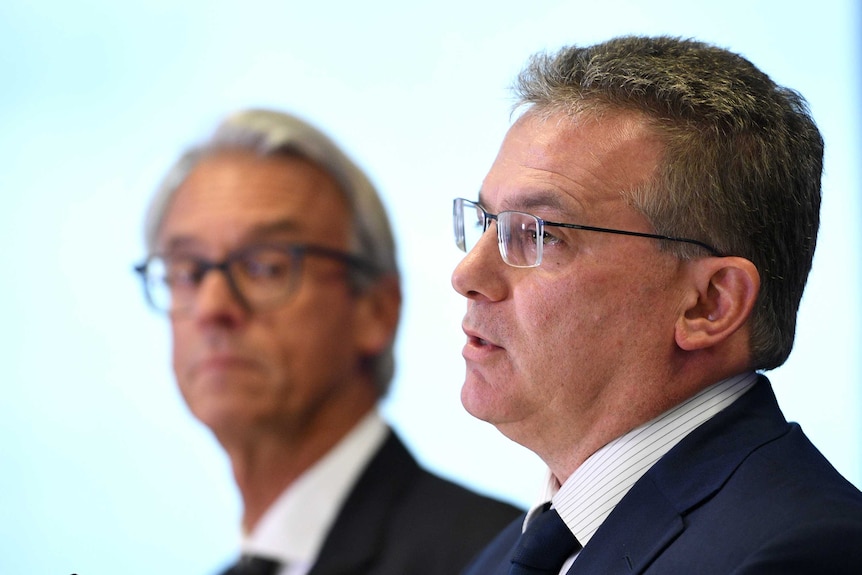 Chris Nikou speaks at an FFA media conference as David Gallop looks on.